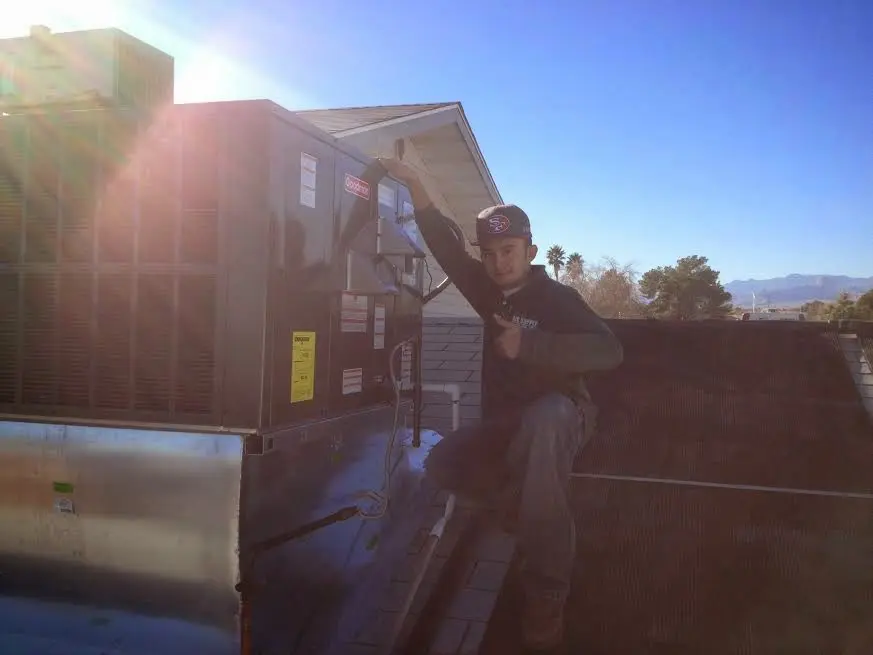 HVAC technician performing Air Duct Cleaning on a rooftop unit in Bensalem